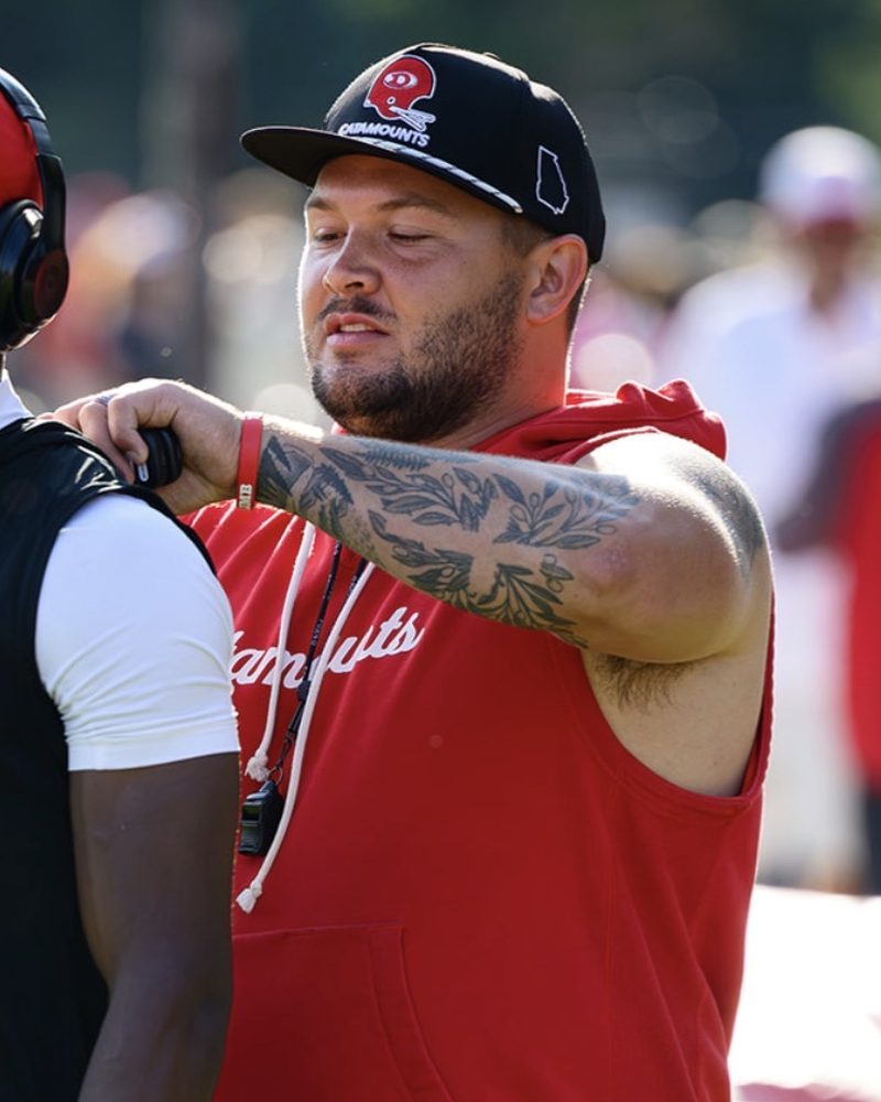 Coach Seay coaching an athlete on the sideline